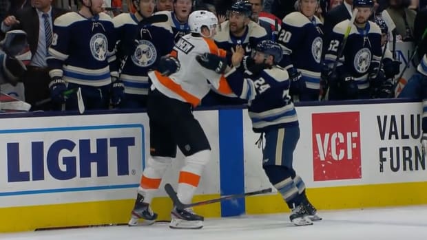 Blue Jackets' Nathan Gerbe fights Flyers' Travis Sanheim in an NHL game